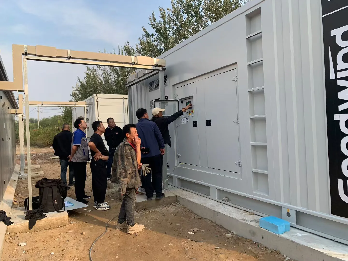 On-site personnel checking a GOODWIND diesel generator control panel at the Beijing central kitchen