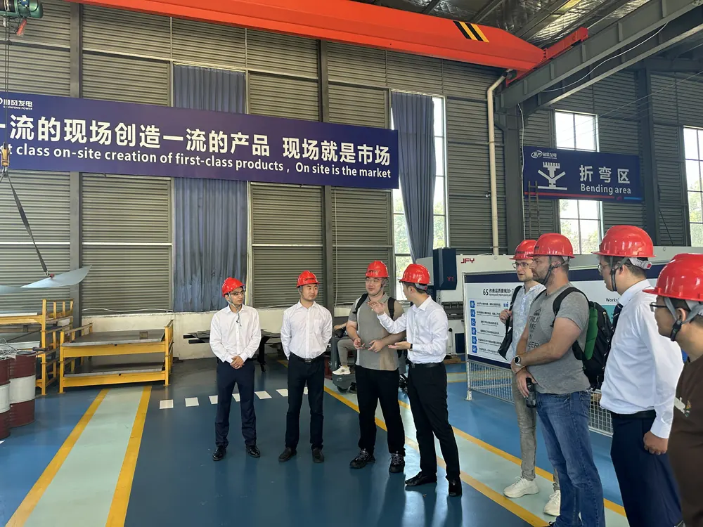 Customers touring the sheet metal bending area at the GOODWIND generator factory