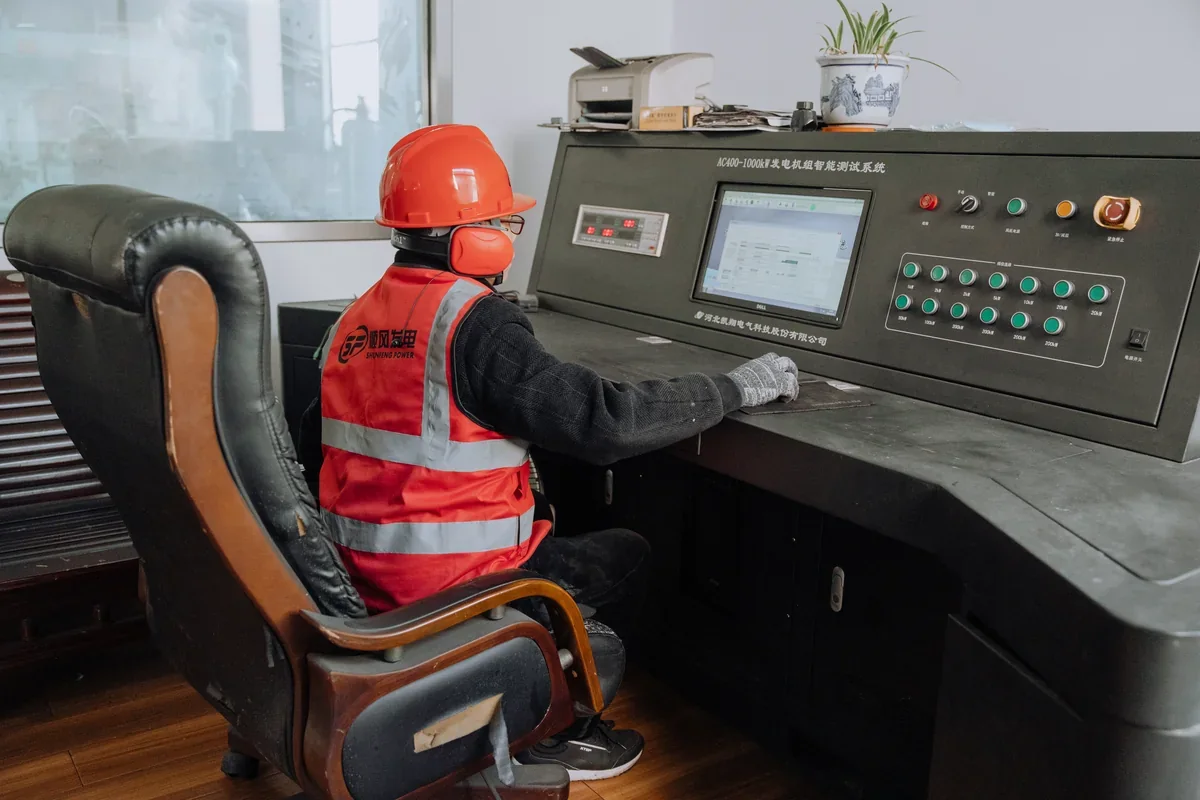 Operator seated at a generator test-system control console