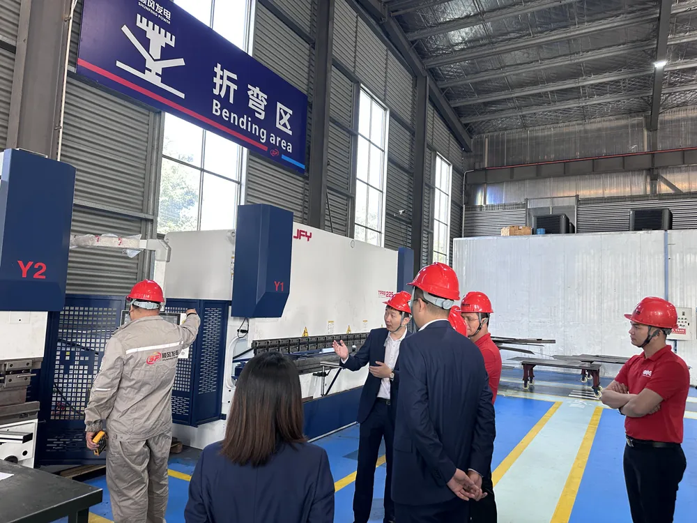 Customers inspecting the sheet metal bending area in the generator factory